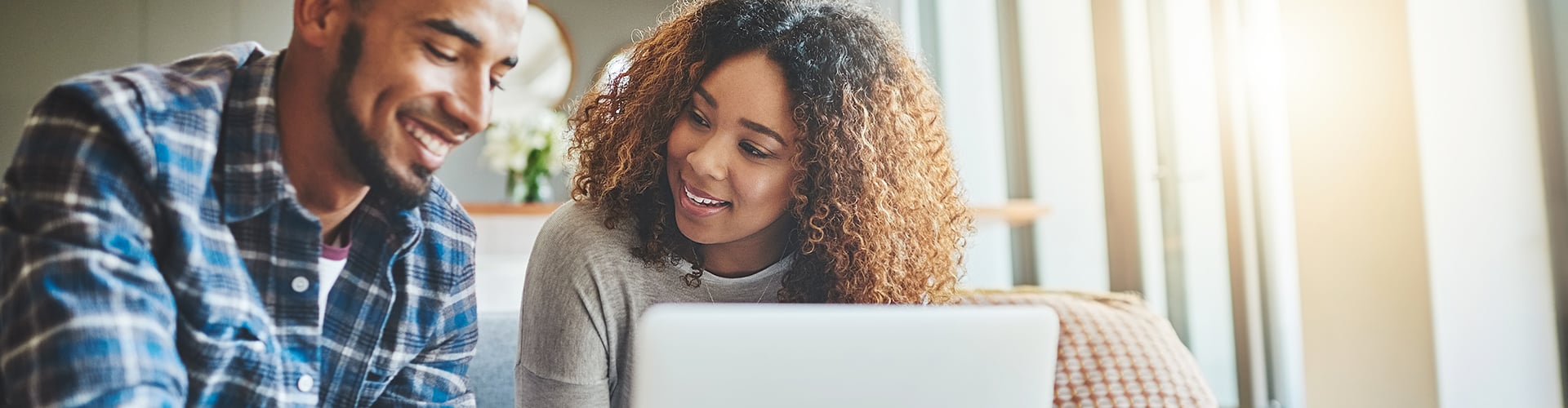 A man and a woman looking at a laptop.