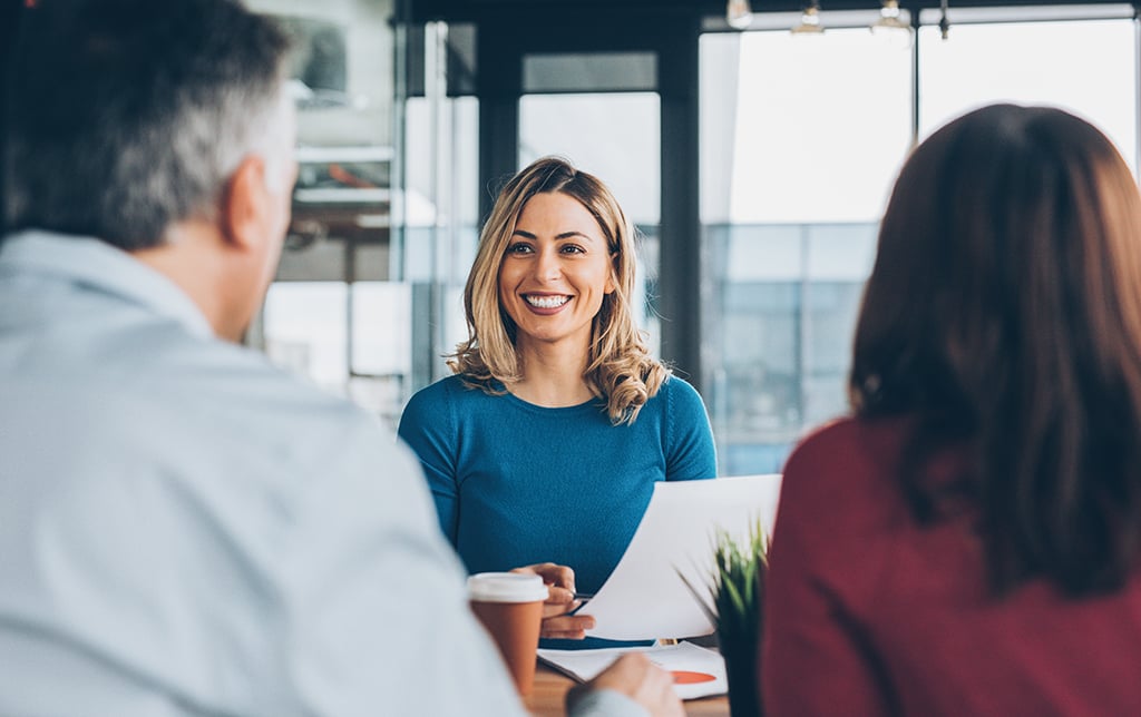 A woman talking to a group of people.