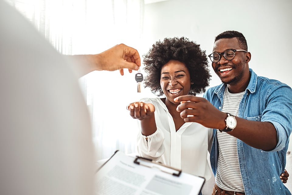 A man and a woman looking at a laptop.